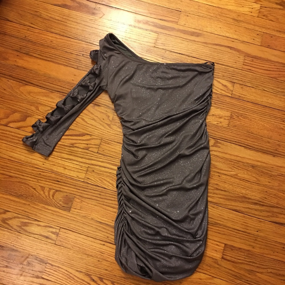 Cute short large glitter dress with one sleeve that exposes skin between bows.